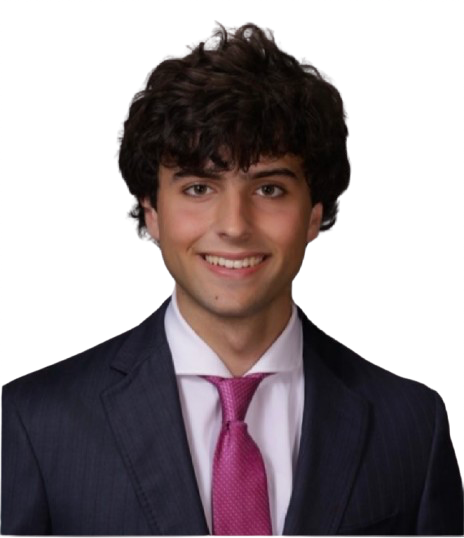 Kyle smiling in a dark suit and a magenta tie, cut out against the page